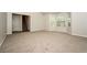 Bright living room with neutral carpeting, fireplace, and ample natural light from large windows at 4438 Tuckahoe Ct, Douglasville, GA 30135