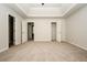 Neutral main bedroom with carpet floor, tray ceiling, and three doors to other rooms at 4438 Tuckahoe Ct, Douglasville, GA 30135