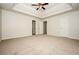 Spacious main bedroom features a tray ceiling, carpet, and multiple doorways at 4438 Tuckahoe Ct, Douglasville, GA 30135