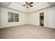 Large bedroom featuring tray ceiling, neutral colors, and plush carpet at 4438 Tuckahoe Ct, Douglasville, GA 30135