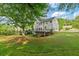 View of backyard featuring a large deck perfect for outdoor entertaining amid lush greenery at 455 Firelite Ln, Suwanee, GA 30024