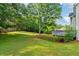 Lush green backyard featuring a deck that overlooks the well-maintained lawn and mature trees at 455 Firelite Ln, Suwanee, GA 30024