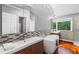 Bright bathroom featuring double vanities, a soaking tub, and modern fixtures at 455 Firelite Ln, Suwanee, GA 30024