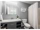 Bathroom features a vanity, toilet, mirror and shower with curtain at 455 Firelite Ln, Suwanee, GA 30024