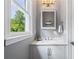 Powder room features a stylish vanity with a large window for natural light at 455 Firelite Ln, Suwanee, GA 30024