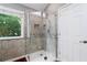Bathroom featuring a glass-enclosed shower and white tile at 455 Firelite Ln, Suwanee, GA 30024