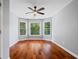 Empty bedroom with hardwood floors, bay window, and gray walls at 455 Firelite Ln, Suwanee, GA 30024
