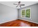 Bright bedroom with hardwood floors, ceiling fan, and a double window at 455 Firelite Ln, Suwanee, GA 30024