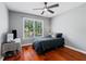 Bedroom featuring hardwood floors, ceiling fan, window, bed, and desk at 455 Firelite Ln, Suwanee, GA 30024