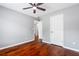 Bedroom with hardwood floors features a ceiling fan and white doors at 455 Firelite Ln, Suwanee, GA 30024