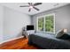 Bedroom featuring hardwood floors, ceiling fan, window, bed, and desk at 455 Firelite Ln, Suwanee, GA 30024
