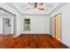 Large bedroom with hardwood floors, a ceiling fan, and many access doors at 455 Firelite Ln, Suwanee, GA 30024