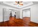 Spacious bedroom has a ceiling fan, hardwood floors and access to other rooms at 455 Firelite Ln, Suwanee, GA 30024