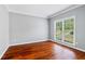Bright bedroom with hardwood floors, crown molding, and a large window overlooking the front yard at 455 Firelite Ln, Suwanee, GA 30024