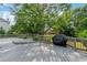 An outdoor deck features a grill and is surrounded by lush greenery, offering a serene retreat at 455 Firelite Ln, Suwanee, GA 30024
