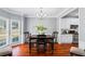 Elegant dining room with hardwood floors, a stylish chandelier, and plenty of natural light at 455 Firelite Ln, Suwanee, GA 30024