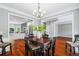 Open-concept dining area with hardwood floors, seamlessly connecting to the modern kitchen at 455 Firelite Ln, Suwanee, GA 30024