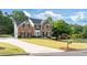 Charming brick home with a long driveway and manicured lawn, set in a lush, green neighborhood at 455 Firelite Ln, Suwanee, GA 30024