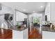Kitchen island with granite countertops and stainless steel appliances, flowing into the dining area at 455 Firelite Ln, Suwanee, GA 30024