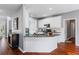 Well-lit kitchen island with white cabinetry and granite countertops at 455 Firelite Ln, Suwanee, GA 30024