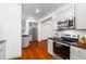 Modern kitchen with stainless steel appliances and beautiful wood floors at 455 Firelite Ln, Suwanee, GA 30024