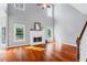 Sun-filled living room features vaulted ceilings, fireplace with decorative mantle and hardwood floors at 455 Firelite Ln, Suwanee, GA 30024