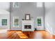 Bright living room features vaulted ceilings, hardwood floors and fireplace with decorative mantle at 455 Firelite Ln, Suwanee, GA 30024