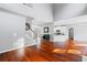 Open-concept living area with hardwood floors and a staircase, flows into kitchen at 455 Firelite Ln, Suwanee, GA 30024