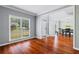 Sun-filled living room with hardwood floors and open access to the dining room at 455 Firelite Ln, Suwanee, GA 30024