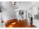 Sun-filled living room showcases fireplace, hardwood floors, stairway, and an open floor plan at 455 Firelite Ln, Suwanee, GA 30024