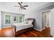 Main bedroom features hardwood floors, ceiling fan, windows and tray ceiling at 455 Firelite Ln, Suwanee, GA 30024