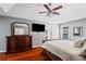 Main bedroom features hardwood floors, TV, ceiling fan and tray ceiling at 455 Firelite Ln, Suwanee, GA 30024