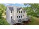 Expansive back of home featuring a large deck, neutral siding, and picturesque green surroundings at 455 Firelite Ln, Suwanee, GA 30024