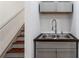 Convenient utility sink with stainless steel basin and modern faucet under stairs at 455 Firelite Ln, Suwanee, GA 30024
