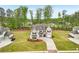 Aerial view of a grand two-story home with a large yard and mature trees at 6555 Hawkins Manor Dr, Cumming, GA 30040
