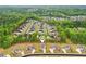 Overhead shot of a lush green neighborhood with luxurious homes and tree-lined streets at 6555 Hawkins Manor Dr, Cumming, GA 30040