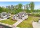 Aerial view of a large two-story home with a well-maintained lawn and a driveway at 6555 Hawkins Manor Dr, Cumming, GA 30040