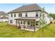 View of the home’s back exterior highlighting the covered patio and landscaped yard at 6555 Hawkins Manor Dr, Cumming, GA 30040