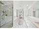 Modern bathroom featuring a glass shower, soaking tub, and double sink vanity with white marble counters at 6555 Hawkins Manor Dr, Cumming, GA 30040