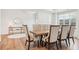 Bright dining room features hardwood floors and large window and comfortable seating for 6 at 6555 Hawkins Manor Dr, Cumming, GA 30040