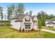 Charming two-story home with a well-manicured lawn and brick accents at 6555 Hawkins Manor Dr, Cumming, GA 30040