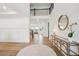 Bright foyer features wood floors, a staircase, and stylish console table with decorative mirror at 6555 Hawkins Manor Dr, Cumming, GA 30040
