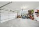 Spacious two car garage featuring a carriage style door and plenty of storage at 6555 Hawkins Manor Dr, Cumming, GA 30040
