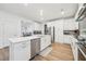 Open concept kitchen with stainless appliances, large island, hardwood floors and recessed lighting at 6555 Hawkins Manor Dr, Cumming, GA 30040