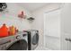 Laundry room featuring side by side washer and dryer, wire shelves, and door to another room at 6555 Hawkins Manor Dr, Cumming, GA 30040