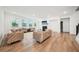 Bright living room features hardwood floors, plush seating, fireplace, and large windows at 6555 Hawkins Manor Dr, Cumming, GA 30040