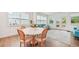 Cozy seating area has natural light, hardwood floors, an adjacent dining area, and double doors at 6555 Hawkins Manor Dr, Cumming, GA 30040