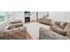 Spacious living room with multiple couches, fireplace, and hardwood floors at 6555 Hawkins Manor Dr, Cumming, GA 30040