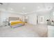 Spacious primary bedroom features tray ceiling, carpet, and space for relaxation and getting ready at 6555 Hawkins Manor Dr, Cumming, GA 30040