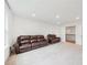 Recreation room featuring two leather sofas, carpet, and a window overlooking the yard at 6555 Hawkins Manor Dr, Cumming, GA 30040
